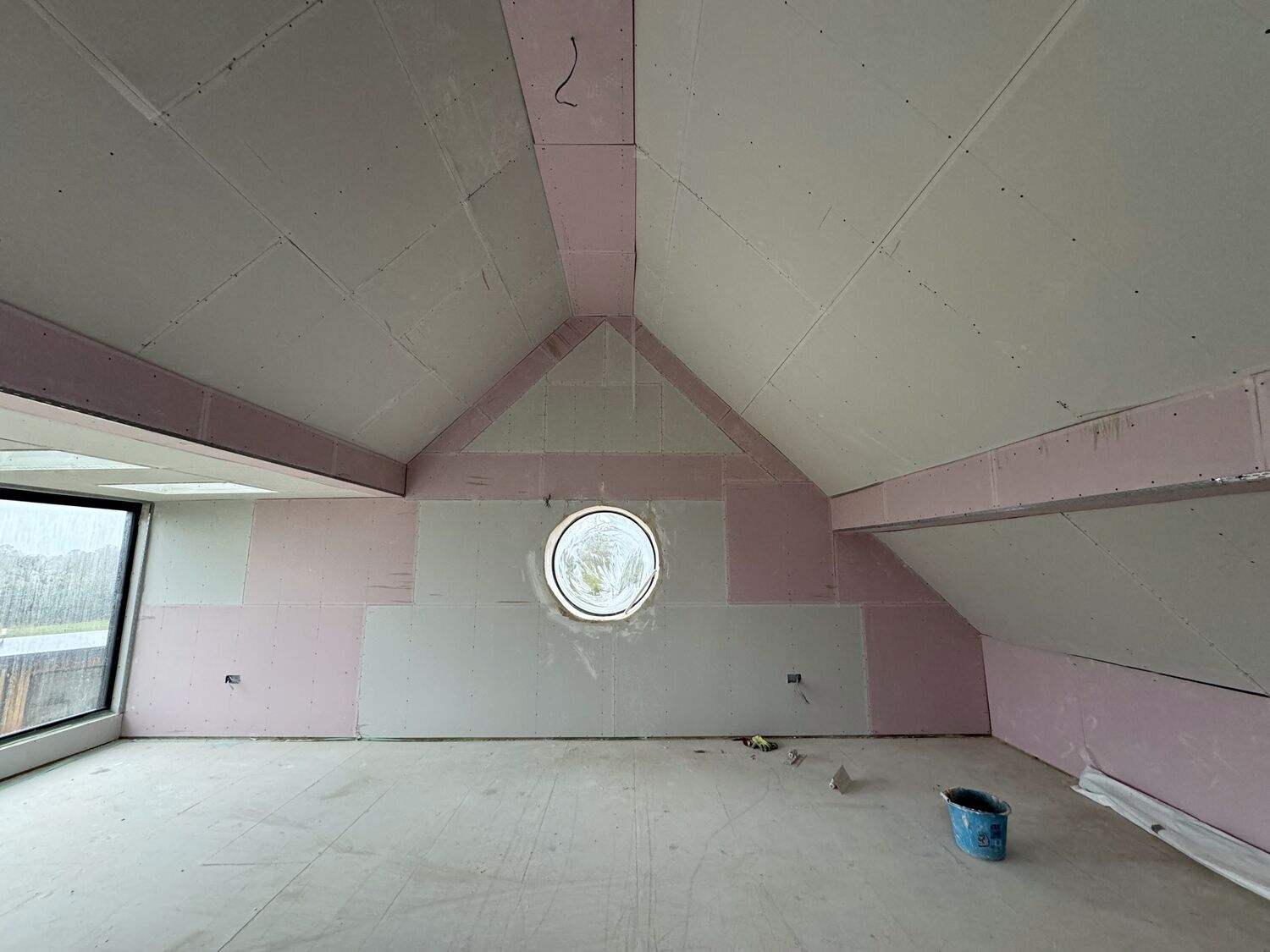 Vaulted room boarded out with circular feature window